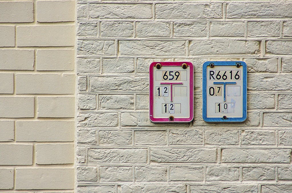 Utilities of numbered signs on a brick wall indicating water supply and intake details.