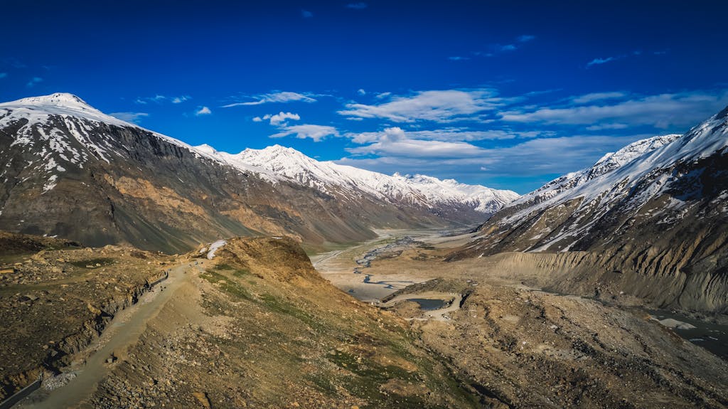 EWC Near Me Stunning view of the snow-capped Himalayas in Zanskar with clear blue skies.