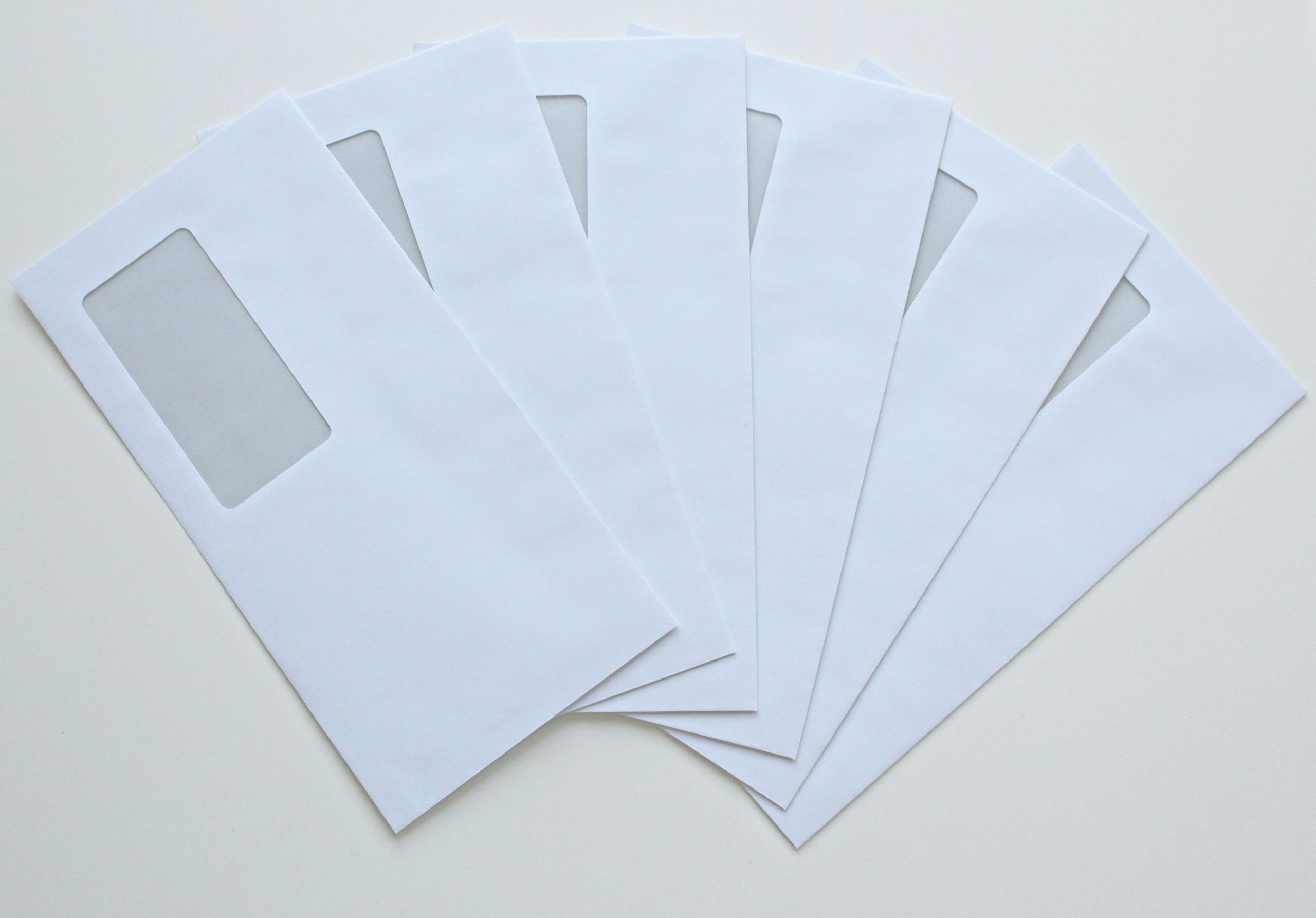 The Globe and Mail A set of white window envelopes fanned out on a flat surface, ready for mailing or office use.