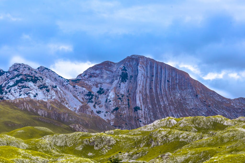 Beautiful Breathtaking view of a vast mountain landscape under a dramatic cloudy sky.