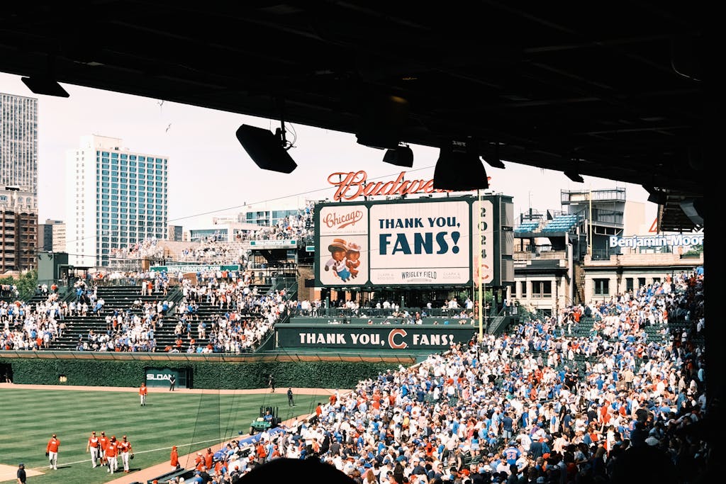 Chicago Cubs  Crowd enjoying a baseball game at Wrigley Field, Chicago's iconic stadium, on a sunny day.