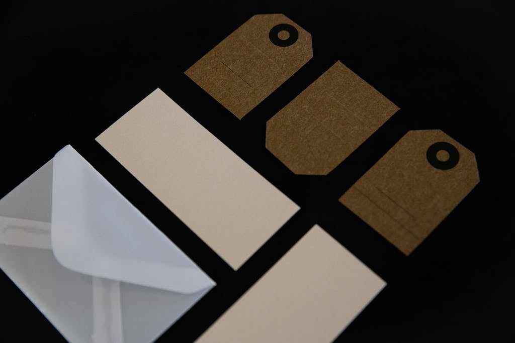 Bolly4u Me Flat lay of envelopes and tags on a dark surface for mockup use.