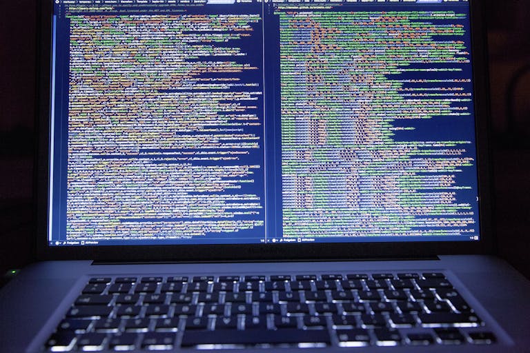 630 Area Code Laptop displaying source code with dual screens for software development.