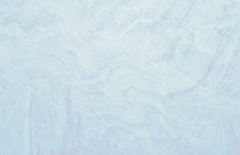Fraboc Light pastel blue marble texture showcasing smooth surface with soft wave patterns, ideal for design use.