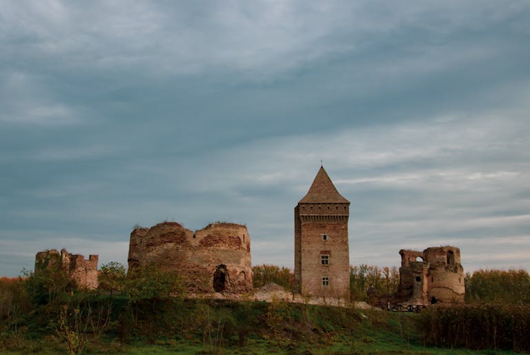 BAC Stock A medieval fortress in Bač, Serbia, showcasing ancient architectural ruins under a dramatic sky.